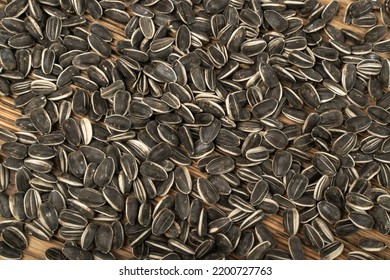 Sunflower Seeds Texture Background. Raw Sunflower Seed Pattern, Sun Flower Grains On Wooden Rustic Table Desk, Fresh Edible Striped Oil Seeds Flat Lay, Top View With Copy Space