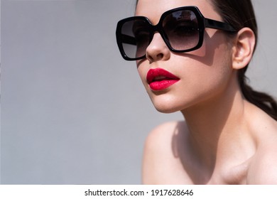 Sunglasses advertising. Closeup girl with sun glasses. Fashion trendy style woman. Beautiful female model