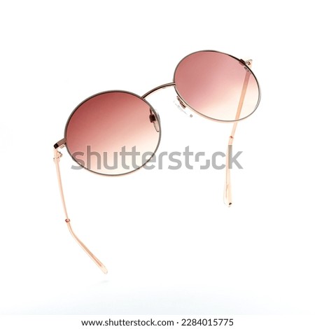 Sunglasses in flying isolated on white and grey background. Retro sunglasses summer woman fashion accessories as design element for promo or advertising banner. Modern metal glasses with frame round