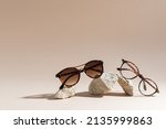 Sunglasses and glasses sale concept. Trendy sunglasses on beige background. Trendy Fashion summer accessories. Copy space for text. Summer sale. Optic store discount poster. Minimalism