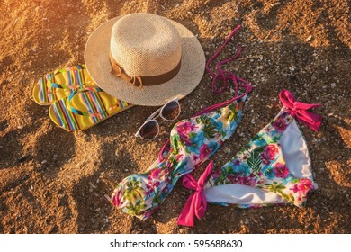 Sunglasses With Hat On Sand. Colorful Swimsuit And Flip Flops. Style Of Summer. Get Away From The Bustle.