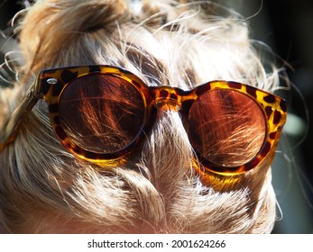 Sunglasses on top of female's head