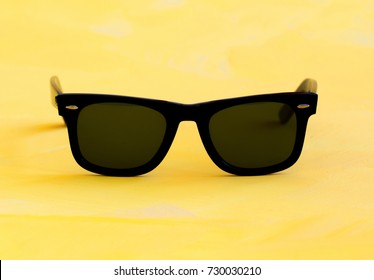 Sunglasses on yellow background
					
