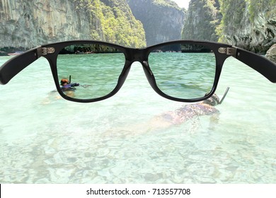 Sunglasses with polarized lens over sea-view background , protection eyes from ultraviolet ray. 