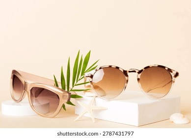 sunglasses with seashell lying on table background. Sunglasses on summer background. Top view flat lay with copy space for text.
