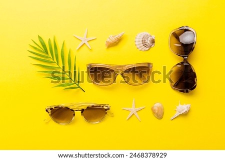 sunglasses with seashell lying on table background. Sunglasses on summer background. Top view flat lay with copy space for text.