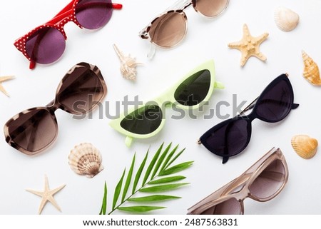 sunglasses with seashell lying on table background. Sunglasses on summer background. Top view flat lay with copy space for text.