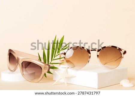 sunglasses with seashell lying on table background. Sunglasses on summer background. Top view flat lay with copy space for text.