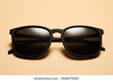 Sunglasses, sunnies isolated on beige sandy background.
