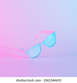 Sunglasses in vibrant bold gradient purple and blue holographic colors. Concept art. Minimal summer surrealism.