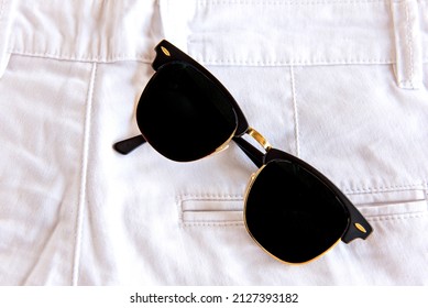 Sunglasses In White Pants Pocket.