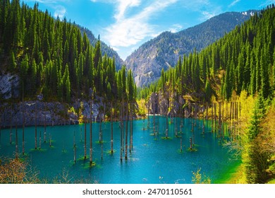 Sunken forest in the mountain lake Kaindy in Kazakhstan. Beautiful mountain natural landscape. Panoramic view of the unique lake. Nature reserve. - Powered by Shutterstock