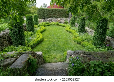 Sunken Garden at Weir Farm National Historic Site. Designed by Cora Weir. Colonial Revival style, small intimate space, defined by stone walls, curved beds, tall arborvitae and dwarf boxwood. 