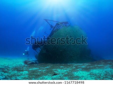 A sunken shipwreck in the mediterranean sea with a scuba diver, Greece