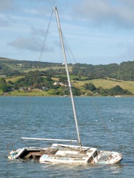 A Sunken Yacht In A River Estuary