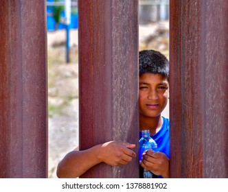 Sunland Park, New Mexico / USA-23 April 2019
Children begging for money or treats from behind the border fence dividing Mexico from the US.