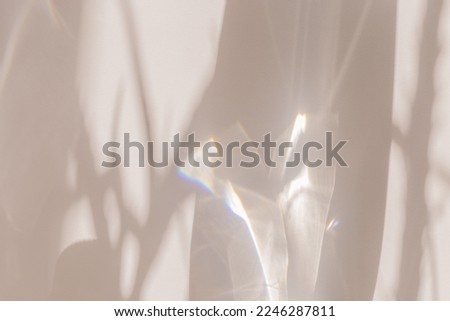 Sunlight background, abstract photo with light and shadow, glare and shine on paper texture, rainbow flare, beige monochrome minimal scene. Natural light and caustic effects, trend aesthetic fon.