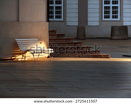 Sunlight bathing an empty bench. Prague