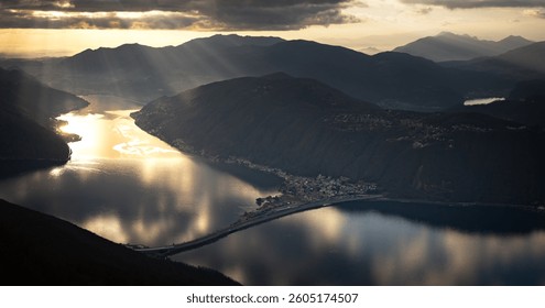 Sunlight Breaking Through Clouds Over Alpine Lake - Powered by Shutterstock - Get 15% off with code: PIKWIZARD15