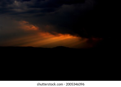 Sunlight breaking through dark clouds