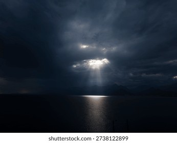 Sunlight breaking through storm clouds on seascape