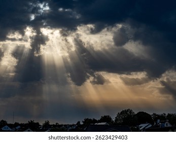 Sunlight breaks through the dark cloudy sky