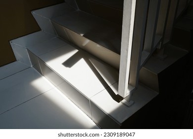 a sunlight come through the window into a stairs
