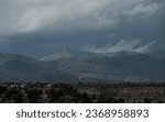 Sunlight coming through clouds over Anderson overlook and Sangre de Cristo, Loas Alamos, New Mexico