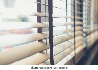 Sunlight coming through venetian blinds by the window