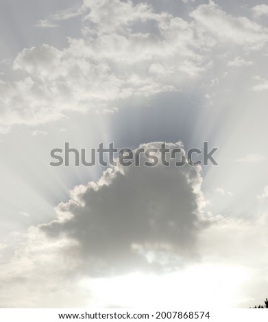 Sunlight escaping from behing a cloud in the sky