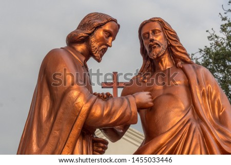 sunlight falling on jesus stone sculpture or statue adds beauty to the photograph saint thomas mount chennai