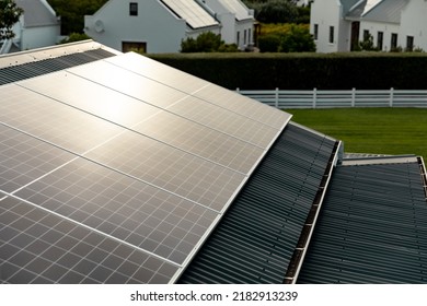 Sunlight Falling On Solar Panels Installed On Rooftop Of Houses, Copy Space. Building, Solar Energy, Electricity, Green Technology And Sustainability Concept.