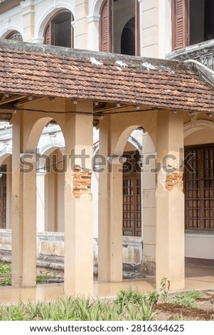 Sunlight filtering through arched windows of a colonial arcade, Lang Song Seminary, Gia Lai, Vietnam
