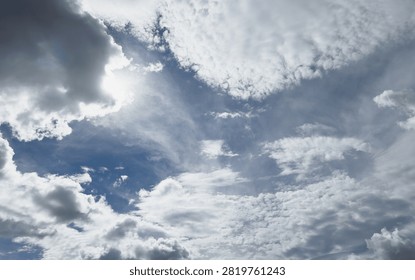 Sunlight filtering through dramatic clouds against a blue sky background – Relaxing views