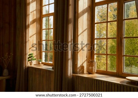 Sunlight filters through large windows in a wooden room. Green trees and a bright outdoor scene are visible. Indoor plants decorative items and curtains create a simple atmosphere.