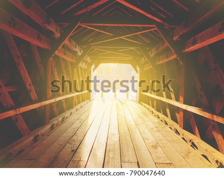Sunlight going inside old covered bridge on Covered Bridge Lane in Sheffield, Massachusetts united states.