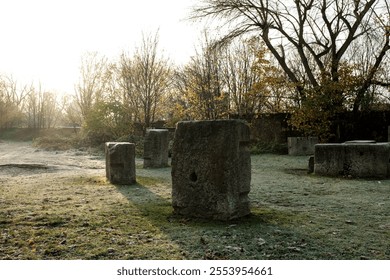 Sunlight illuminates concrete blocks scattered across frosty grass in middlesex filter beds nature reserve, a hidden gem along the river lea in london, on a crisp autumn morning - Powered by Shutterstock