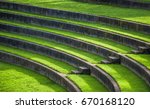 Sunlight leads the eye down the steps of the outdoor grass seating in the Rose Gardens Amphitheater, at Washington Park in Portland, Oregon