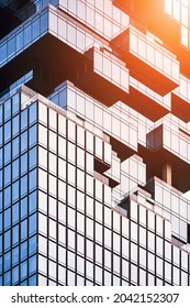 Sunlight on geometric pattern surface of modern glass office building in vertical frame
