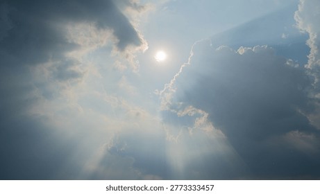 Sunlight peeking through the clouds; sunset.