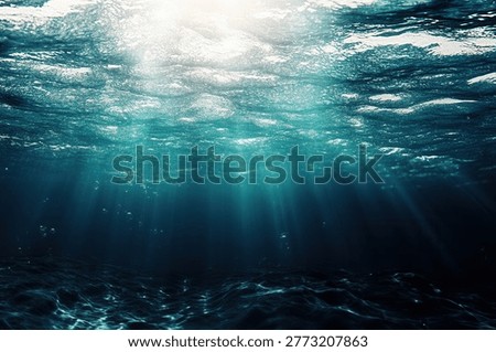 Sunlight penetrates the ocean's surface, casting rays into the depths and creating a tranquil underwater scene with varying shades of blue.