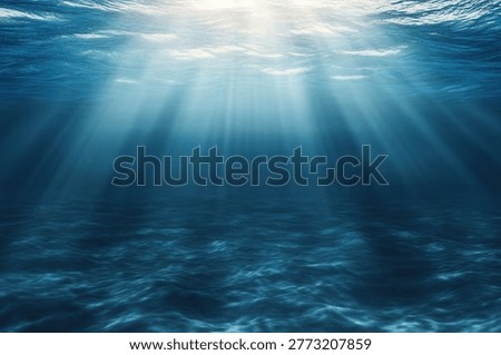 Sunlight pierces the ocean's surface, casting beams of light through the water, creating a serene and ethereal underwater scene.