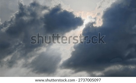 Sunlight pierces through dark clouds, casting radiant beams and shadows, highlighting dramatic sky textures and shifting atmospheric conditions