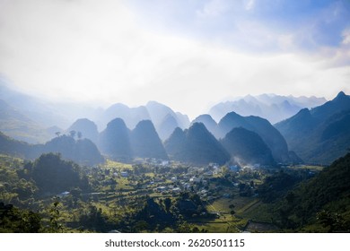 sunlight piercing through clouds on unique mountain formations