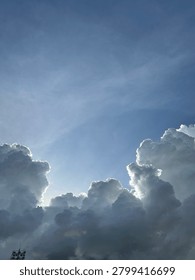 Sunlight piercing through the clouds at sunrise.