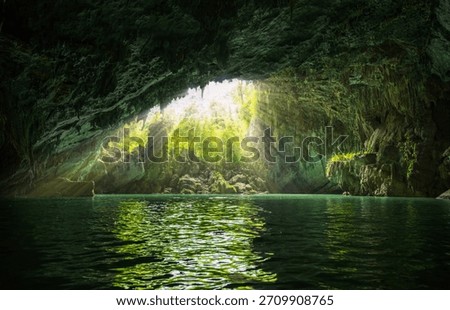 Sunlight Rays Streaming Into Bainiao Cave With Emerald Underground River in Guangxi China
