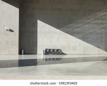 Sunlight reflected on the floor and exterior marble walls and distant public chairs, Garbage bin, lamp. Granite walls and sunlight reflected and shaded. - Powered by Shutterstock