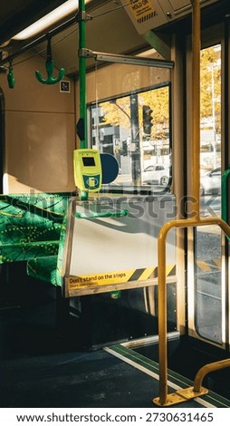 Sunlight reflections on the interior of an old Melbourne tram. The yellow and green interior of a Melbourne tram