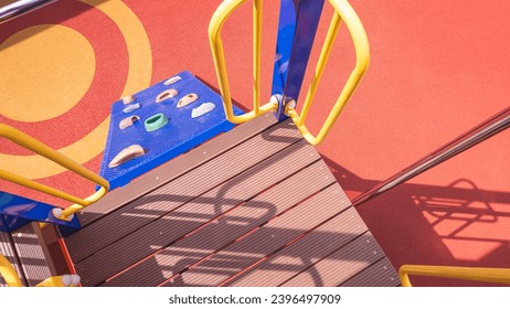 Sunlight and shadow on fiber walkway of climbing playground equipment with jungle gym on safety rubber floor in outdoors playground area at kindergarten, view from above - Shutterstock ID 2396497909