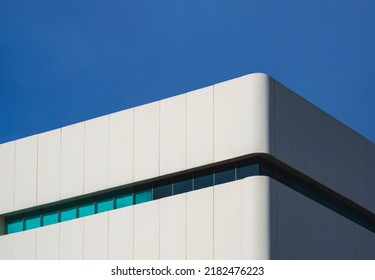 Sunlight And Shadow On Surface Of White Modern Office Building Against Blue Clear Sky In Low Angle And Perspective Side View, Architecture Background Concept